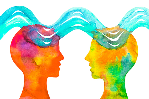 Illustration of two colourful heads facing each other with a wave connecting them